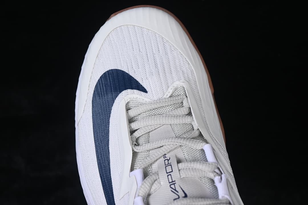 Top view of the toe, laces, and navy Swoosh.