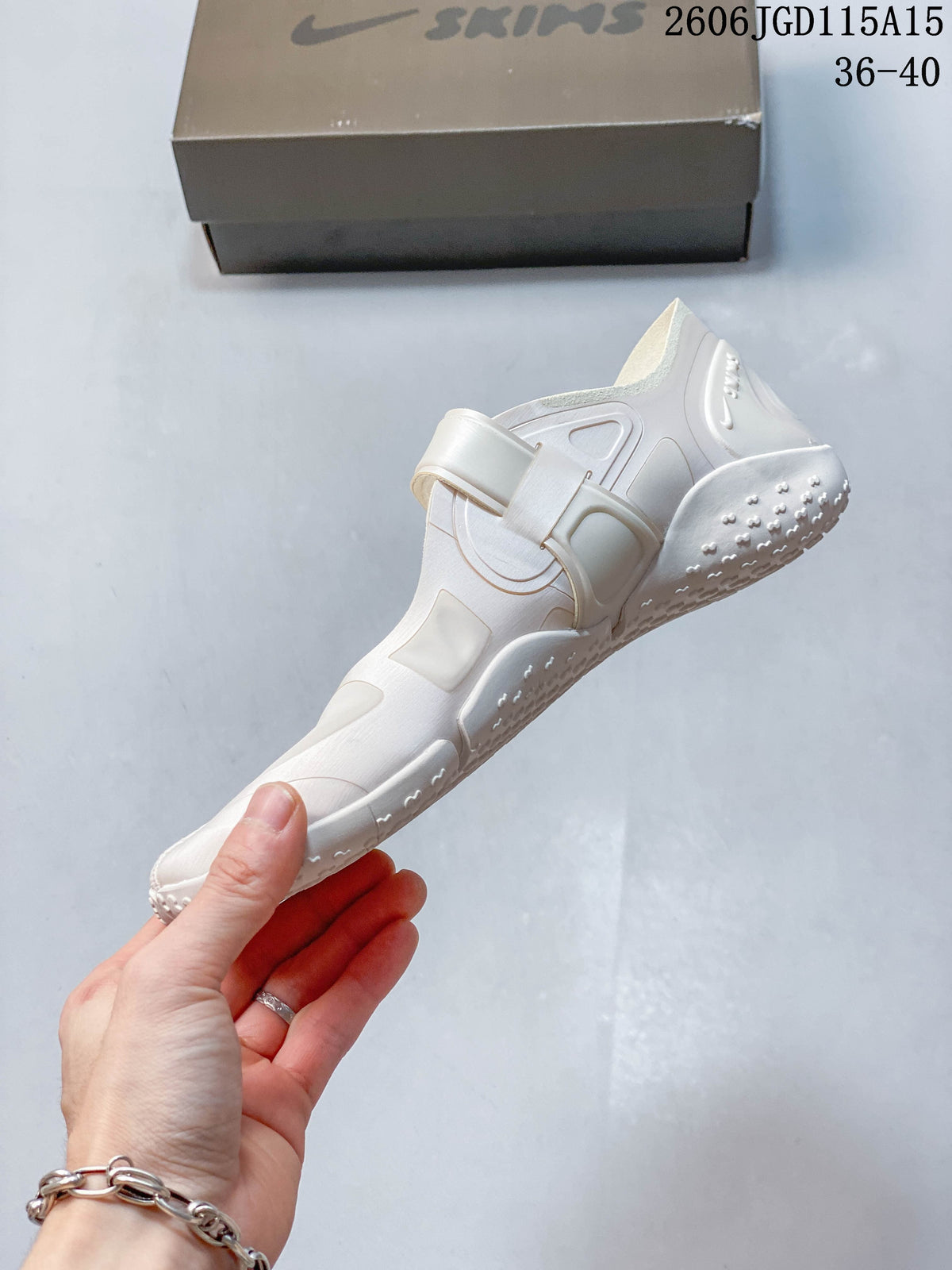 Side profile showing the strap and split-toe shape of a Nike Air Rift shoe