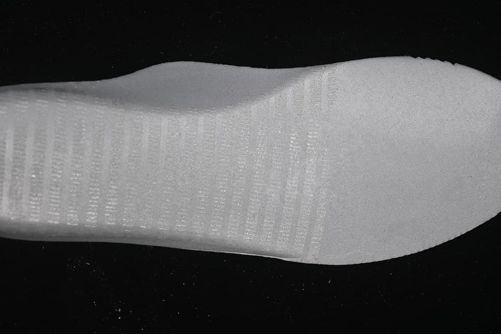 Close-up view of the white textured shoe outsole