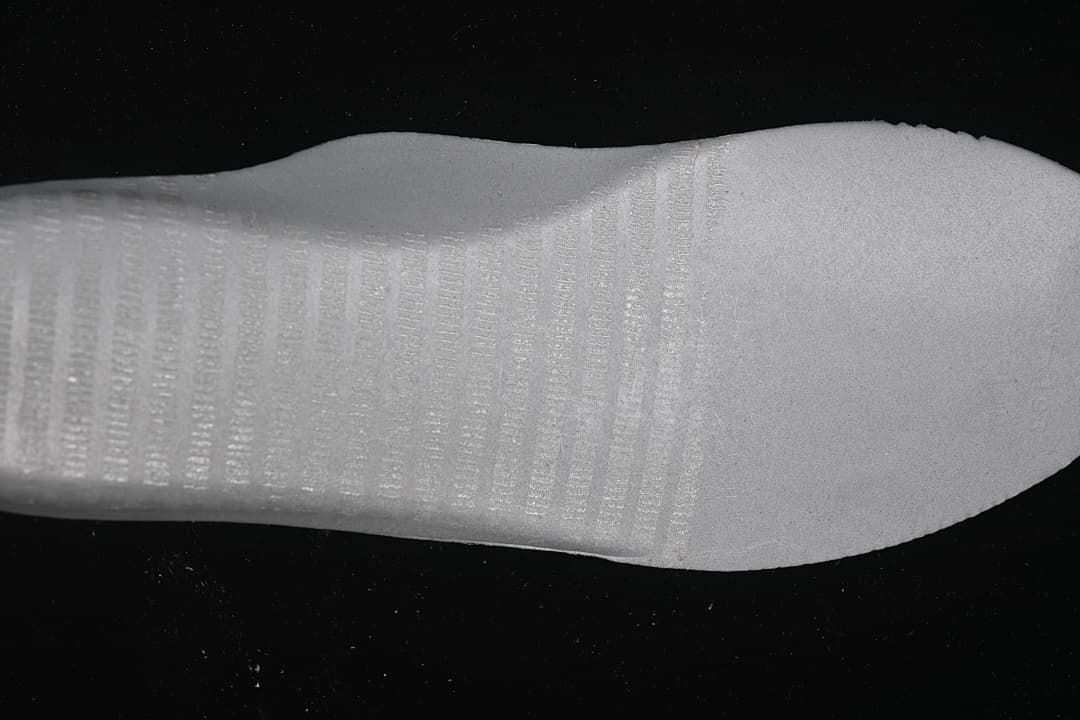 Close-up view of the white textured shoe outsole