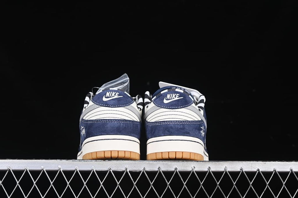 Rear view of both sneakers showing branded heel tabs