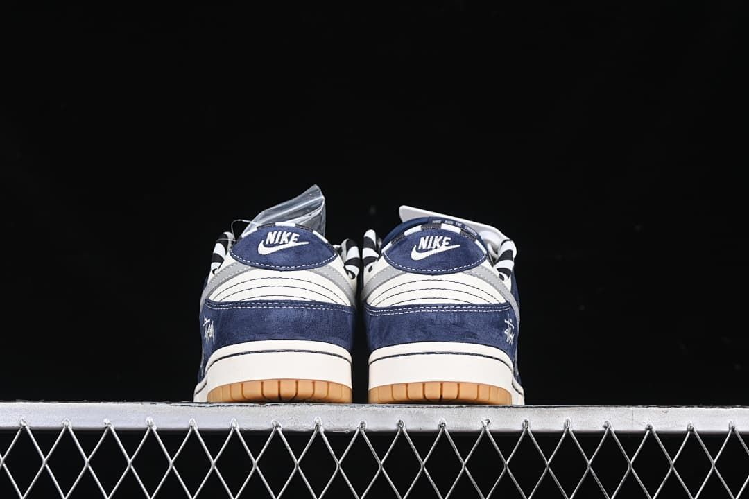 Rear view of both sneakers showing branded heel tabs