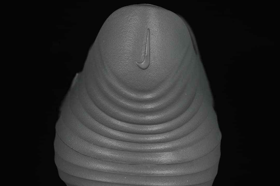 Rear view showing the heel and ridged sole of the grey clog