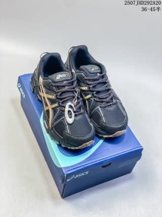 Pair of dark navy and black ASICS Gel-Kahana 8 FL sneakers displayed on an ASICS shoebox.