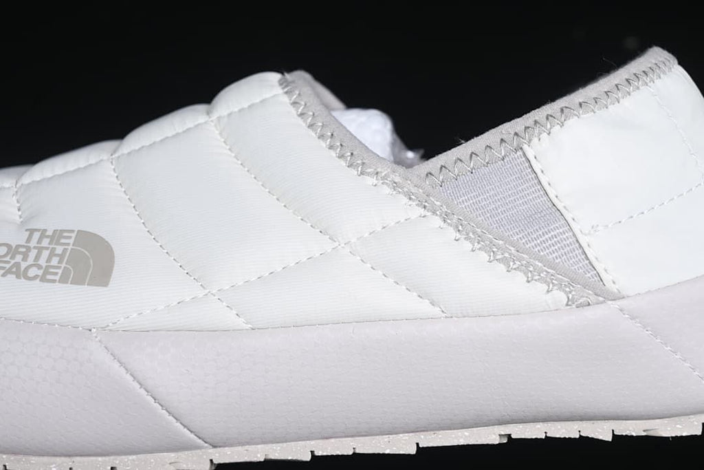Close-up of the quilted upper, side panel, and heel opening.