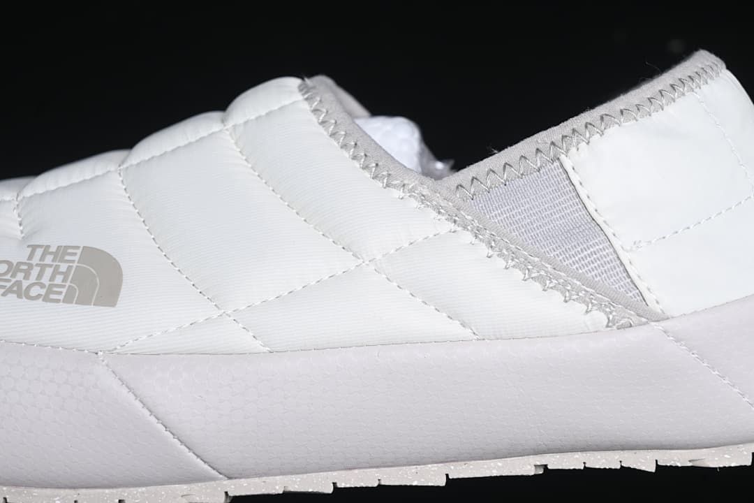 Close-up of the quilted upper, side panel, and heel opening.