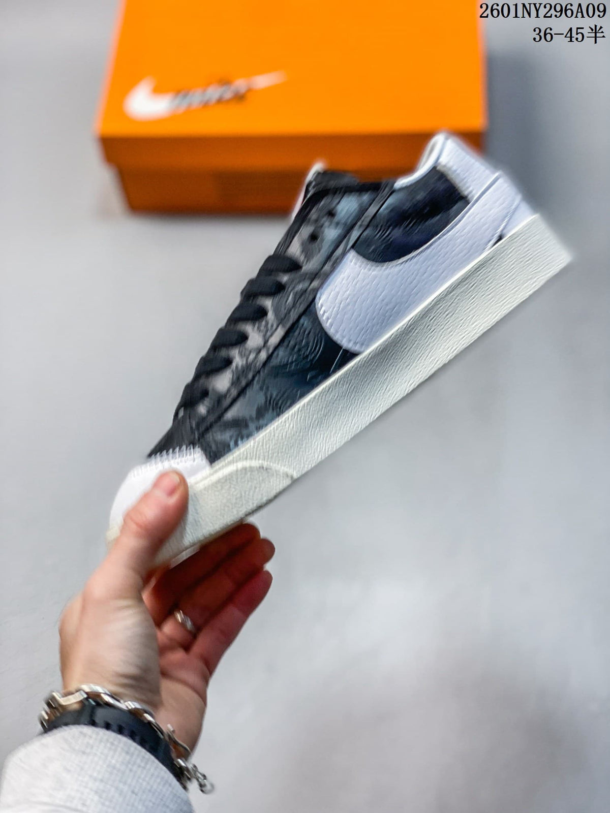 Side profile highlighting the oversized white Swoosh and dark patterned upper.