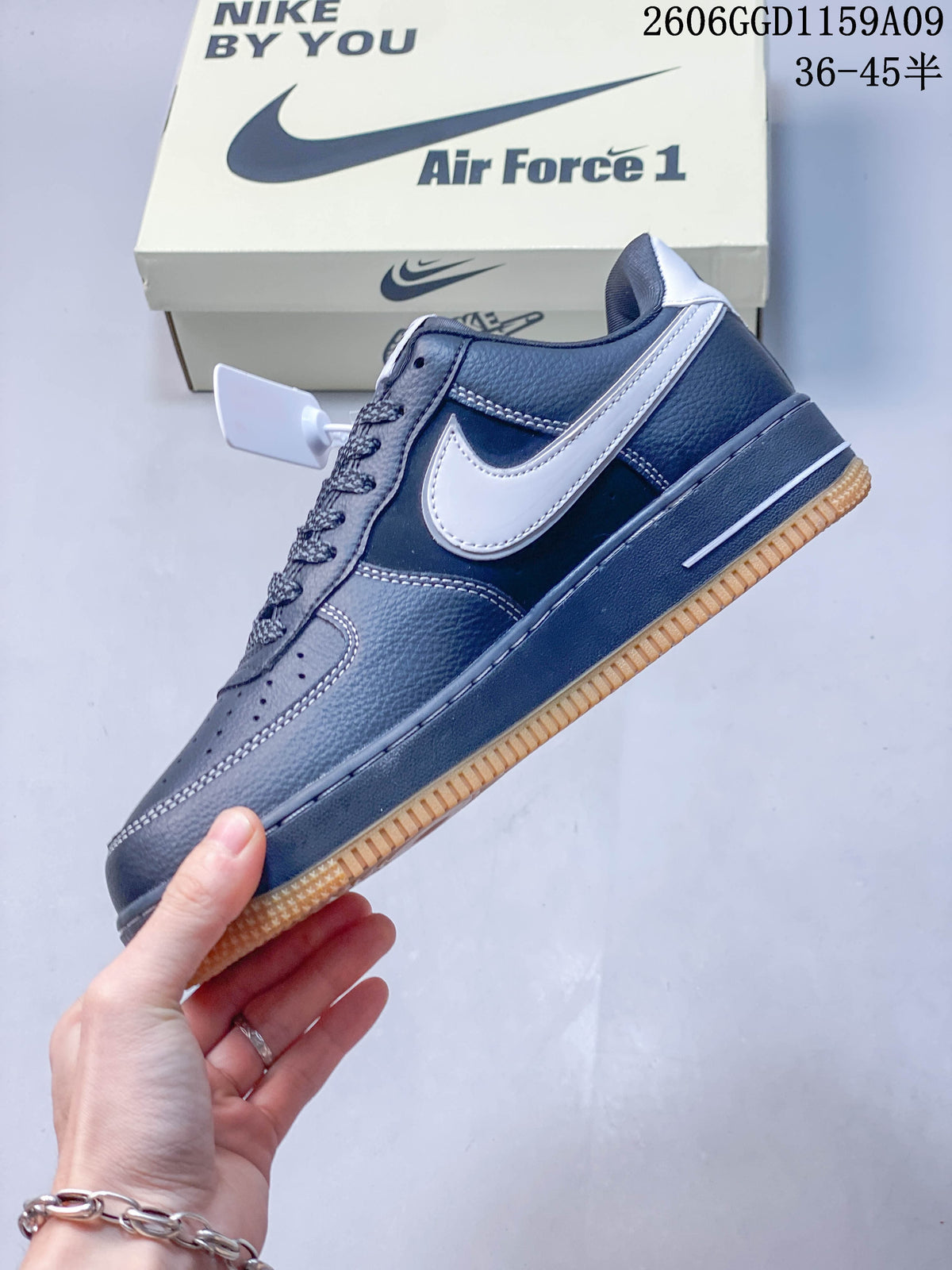 Side view of the navy low-top sneaker with a white Swoosh and gum-colored outsole.