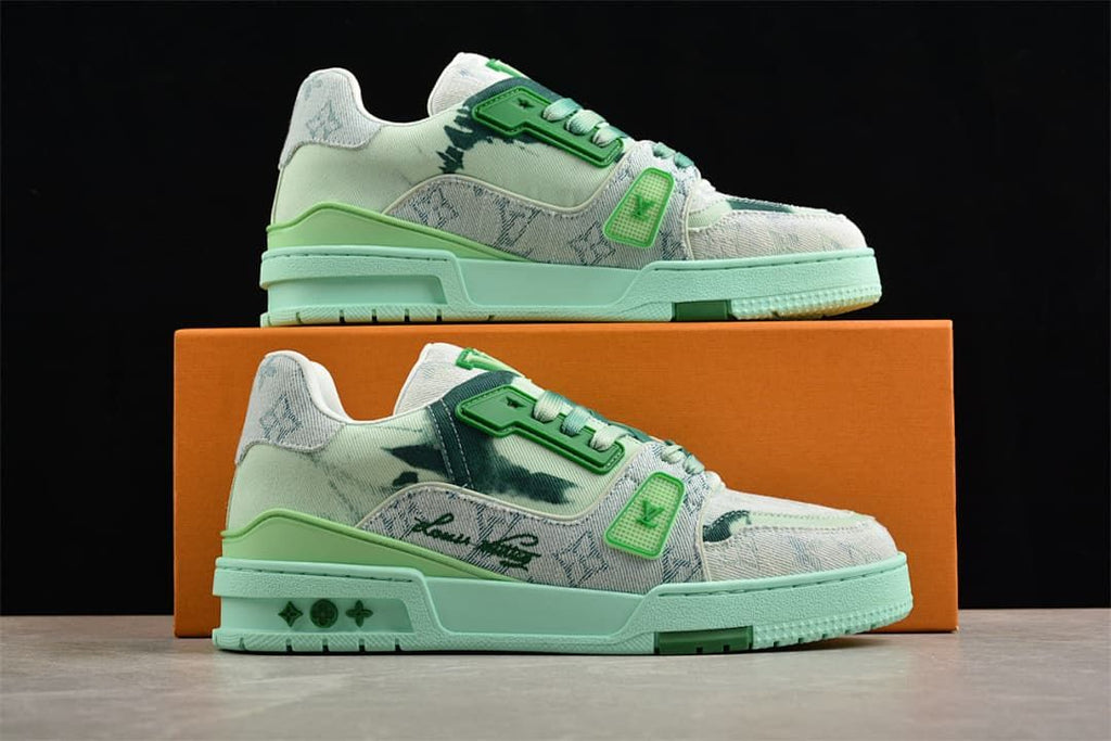 Two sneakers displayed on a box, showing their patterned uppers and green accents.