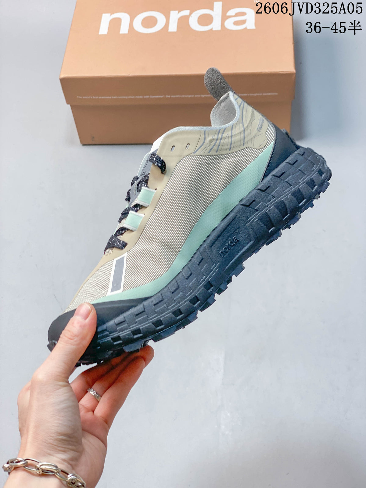 Side view of a beige and mint Norda 001 shoe with dark laces.