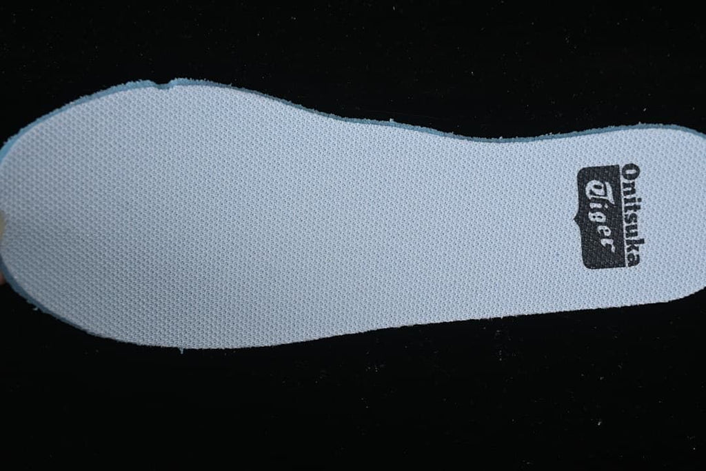 Close-up of a shoe insert with Onitsuka Tiger branding