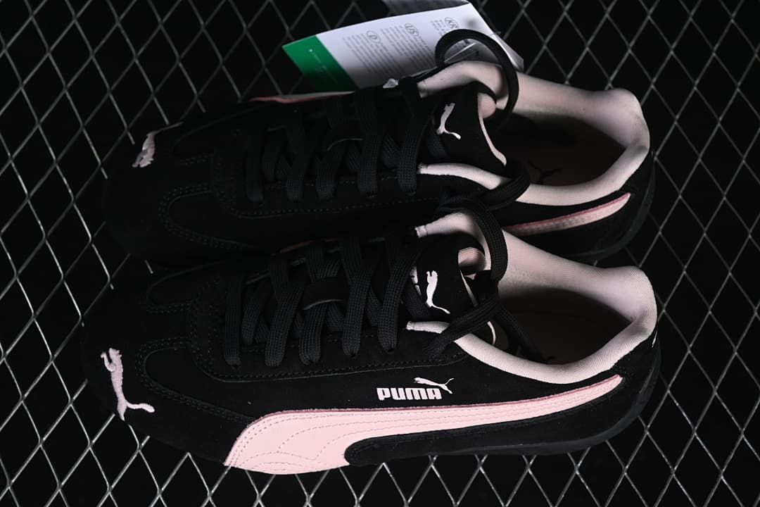 Overhead view of the pair of black and pale pink Puma sneakers.