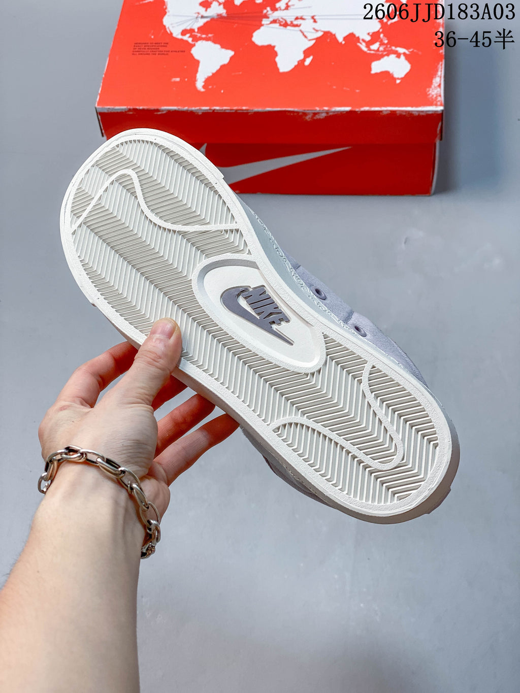 Close-up of the white outsole and its patterned tread on a gray Nike Blazer sneaker