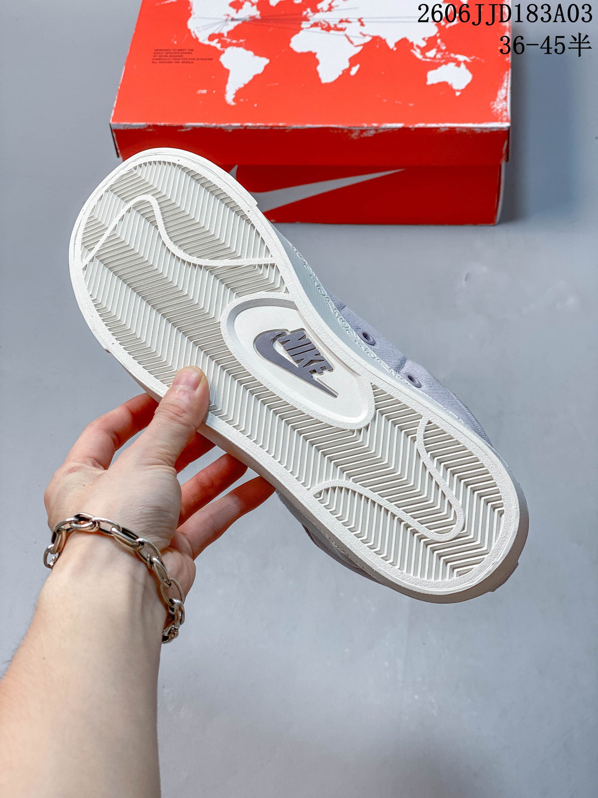 Close-up of the white outsole and its patterned tread on a gray Nike Blazer sneaker