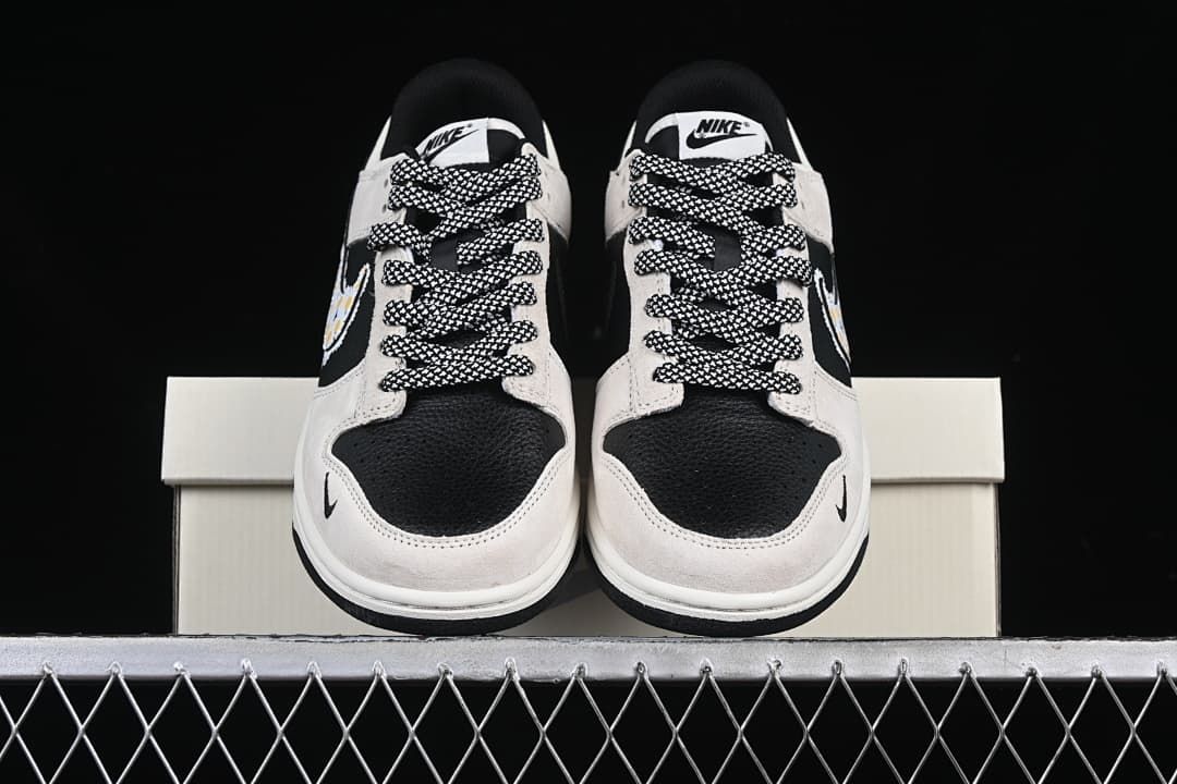 Front view of both sneakers showing black toe panels and patterned laces