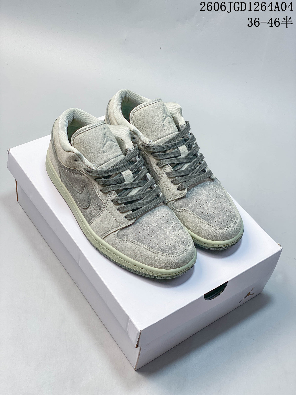 Pair of pale gray Air Jordan 1 Low sneakers with darker gray laces on a white box