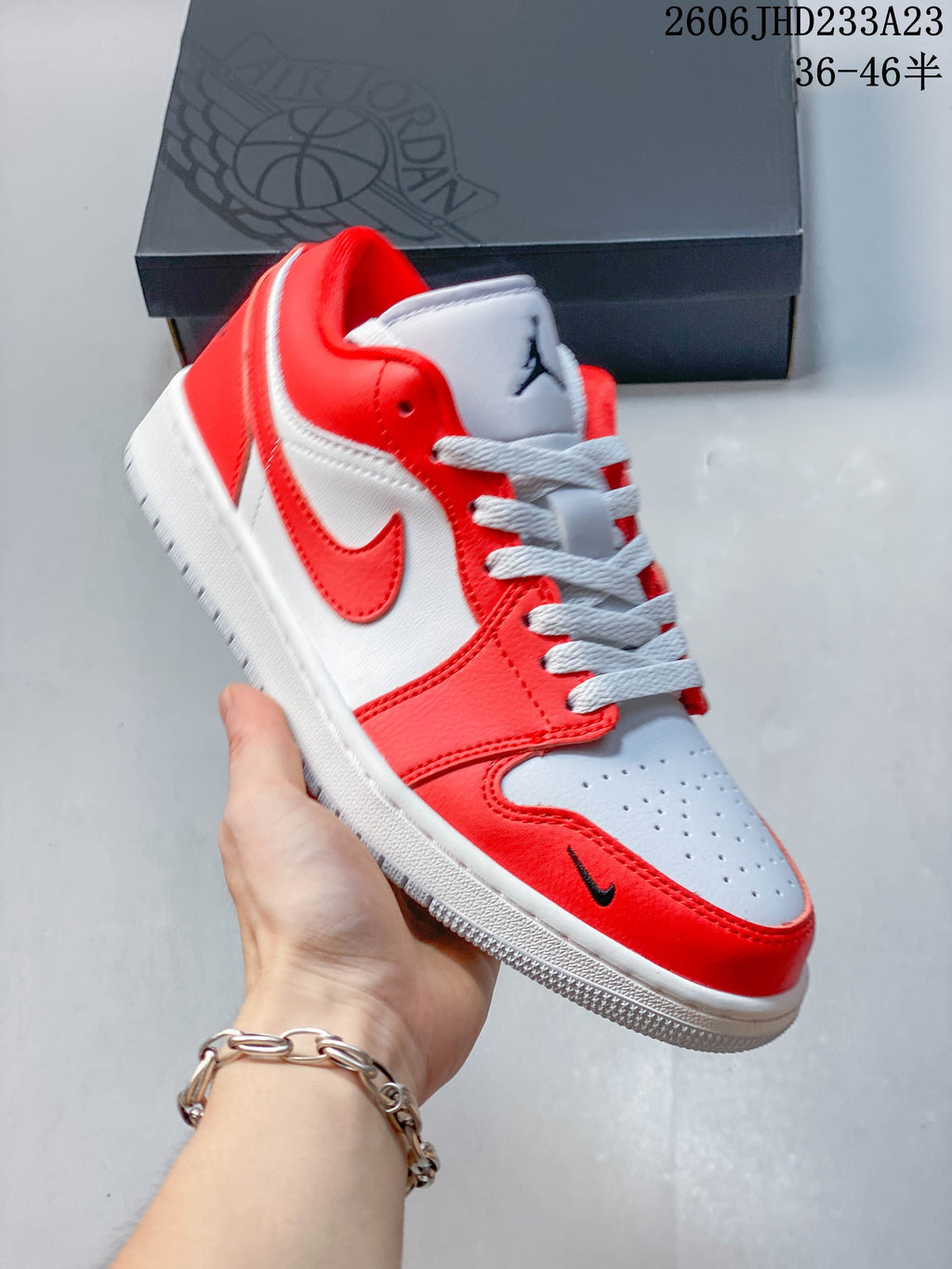 Angled side view of a red and white low-top sneaker