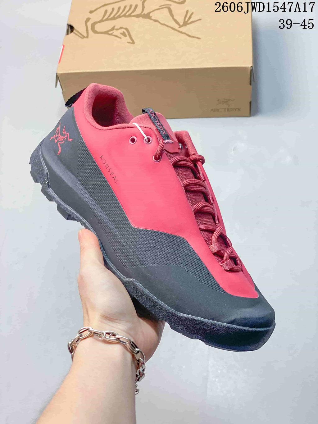 Red and charcoal Arc'teryx Konseal low-top shoe with textured side panels