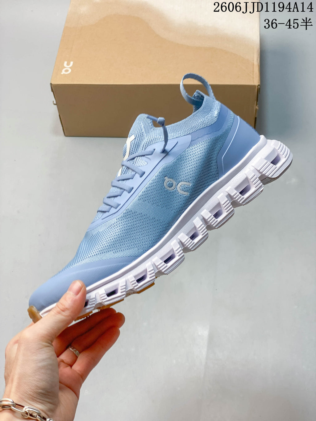Side view of a blue lace-up sneaker with a white segmented outsole.