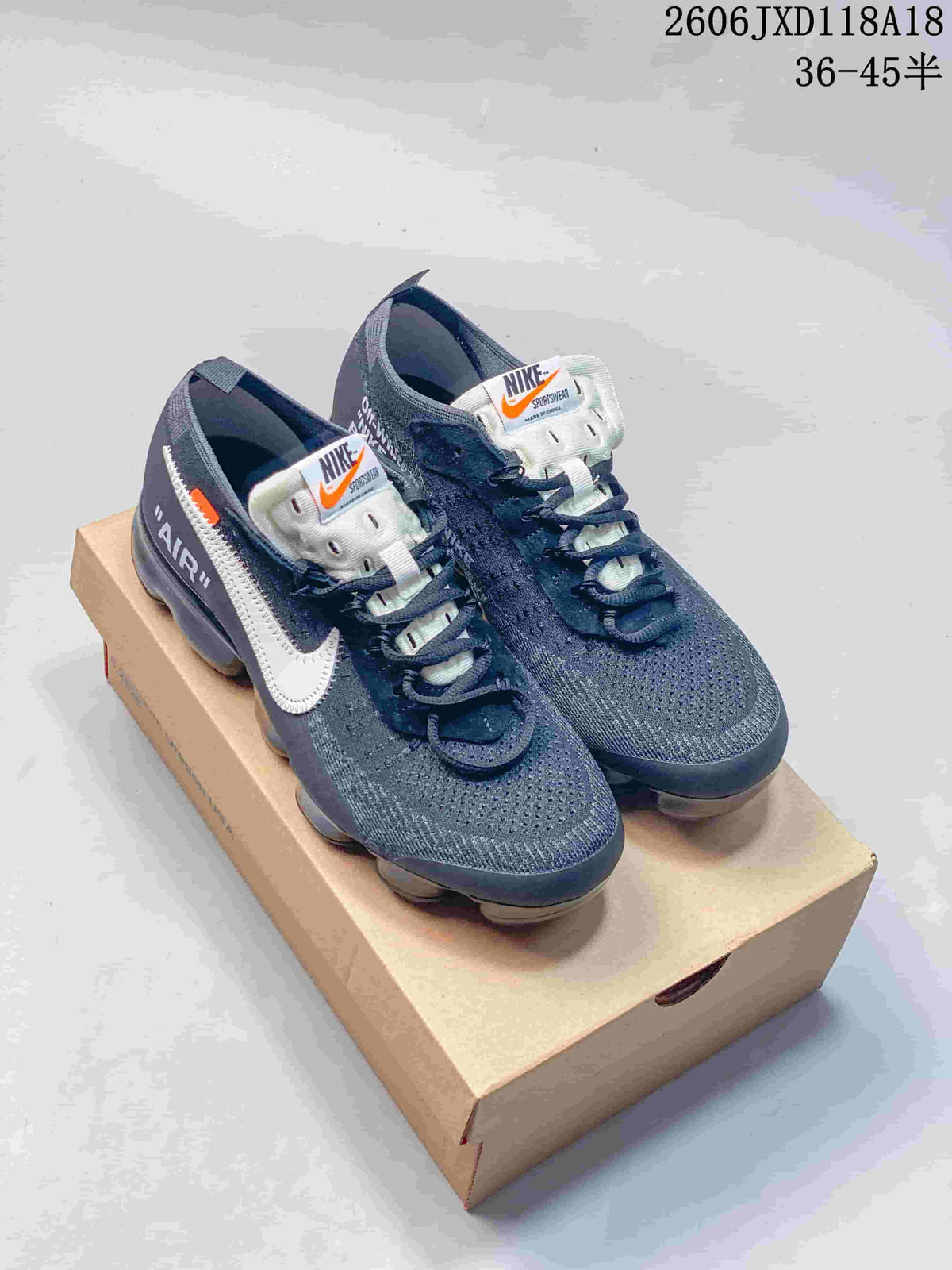 Pair of dark gray Nike Air VaporMax sneakers with white Swooshes and translucent soles, shown on a box; image overlay states sizes 36–45.5.
