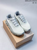 Pair of pale gray and white On Cloudmonster 2 running shoes with blue-gray accents on a shoebox.