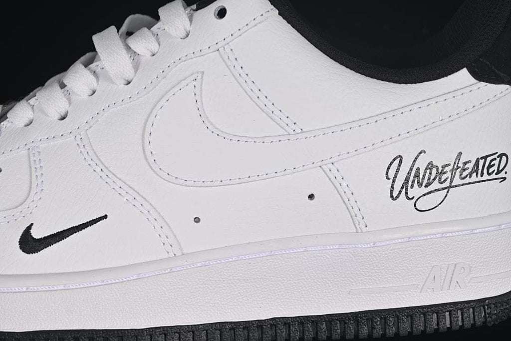 Close-up of the side panel, small Swoosh, and Undefeated script