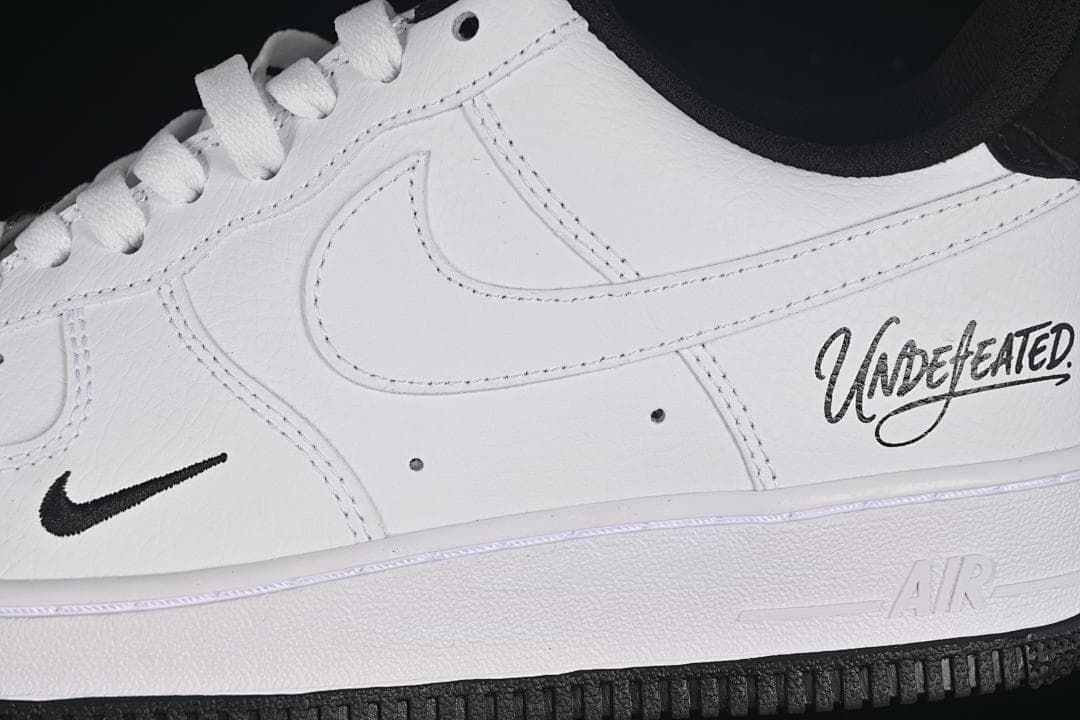 Close-up of the side panel, small Swoosh, and Undefeated script