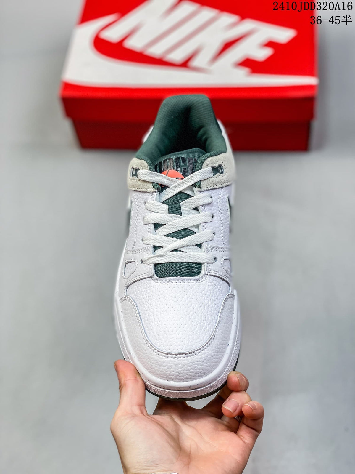 Front view of a white Nike Full Force Low sneaker with green tongue and laces