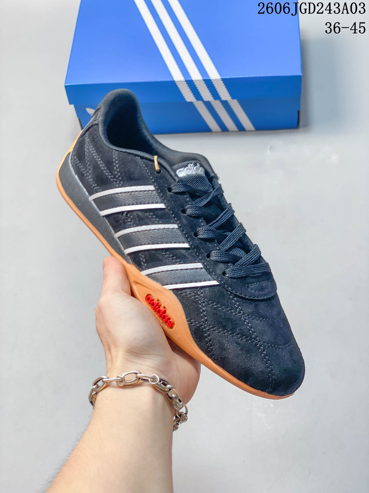 Angled side view of the black adidas Adipista sneaker