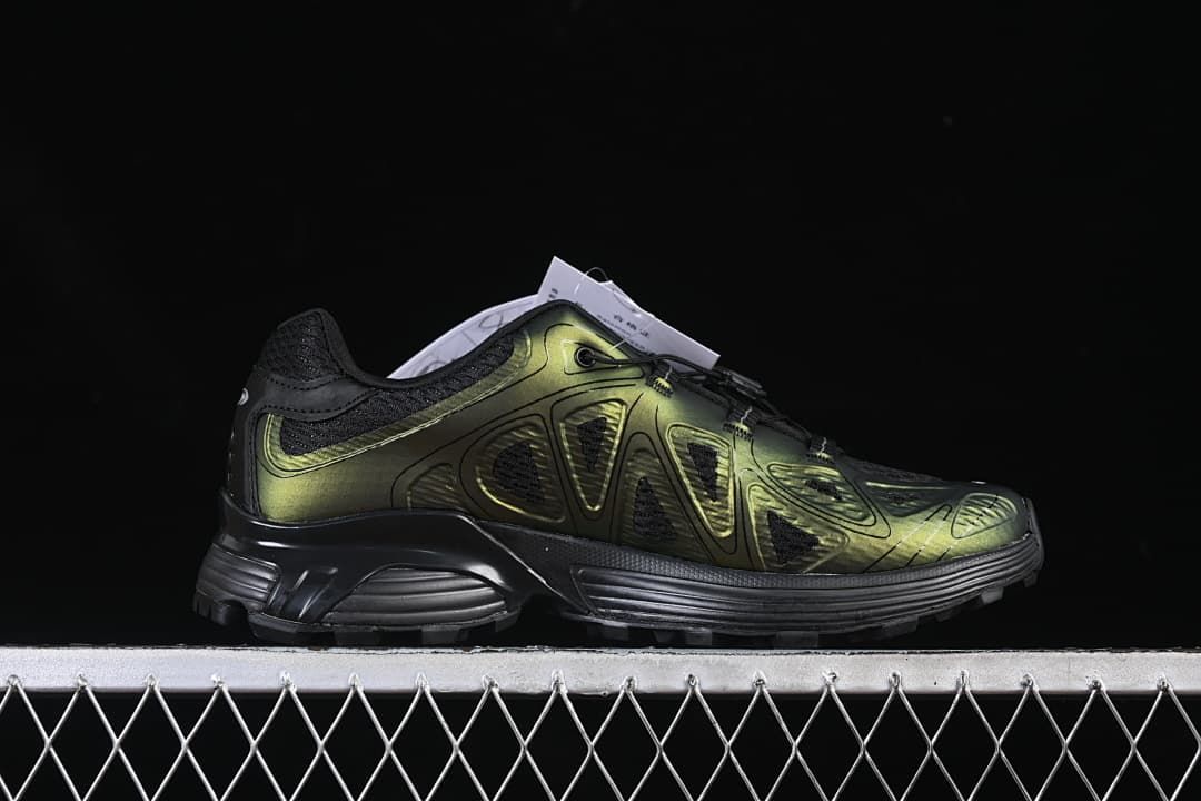 Side profile of the shoe with metallic olive and black detailing