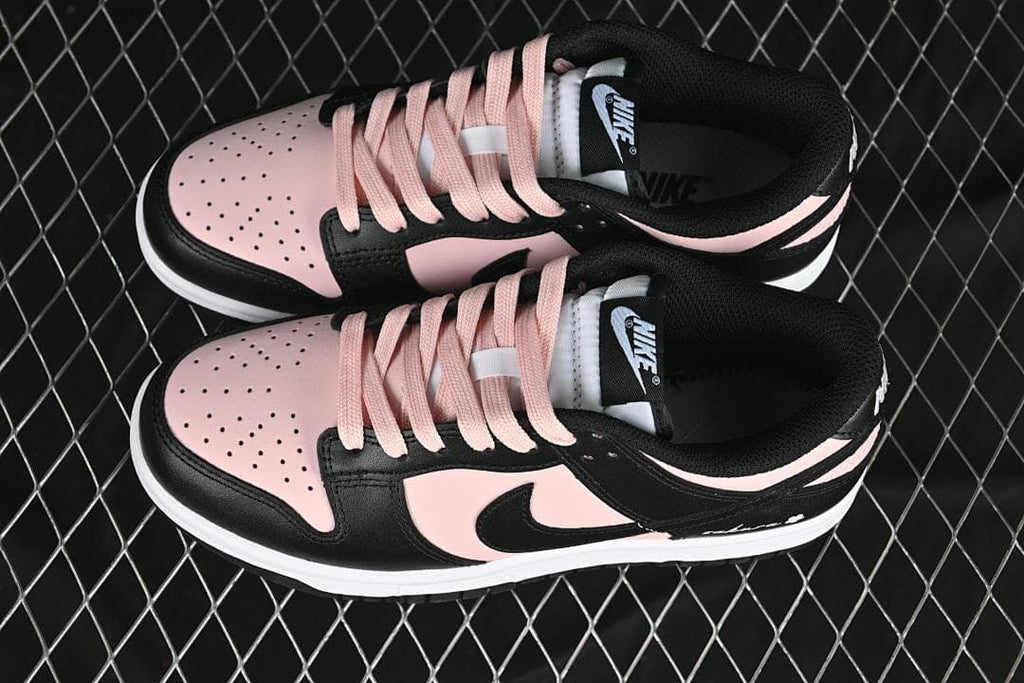 Pair of black and pale pink low-top Dunk sneakers viewed from above