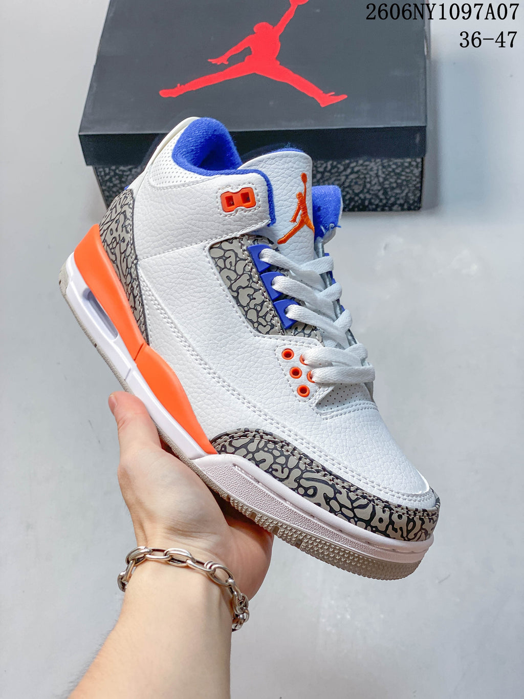 Side view of the Jordan Air Jordan 3 Knicks sneaker with white upper and elephant-print trim