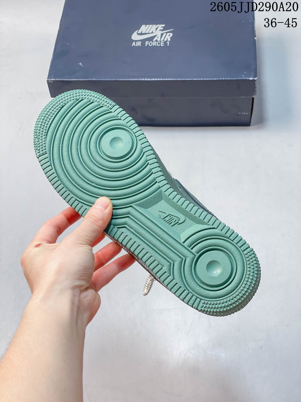 View of the green outsole and circular tread pattern on the sneaker