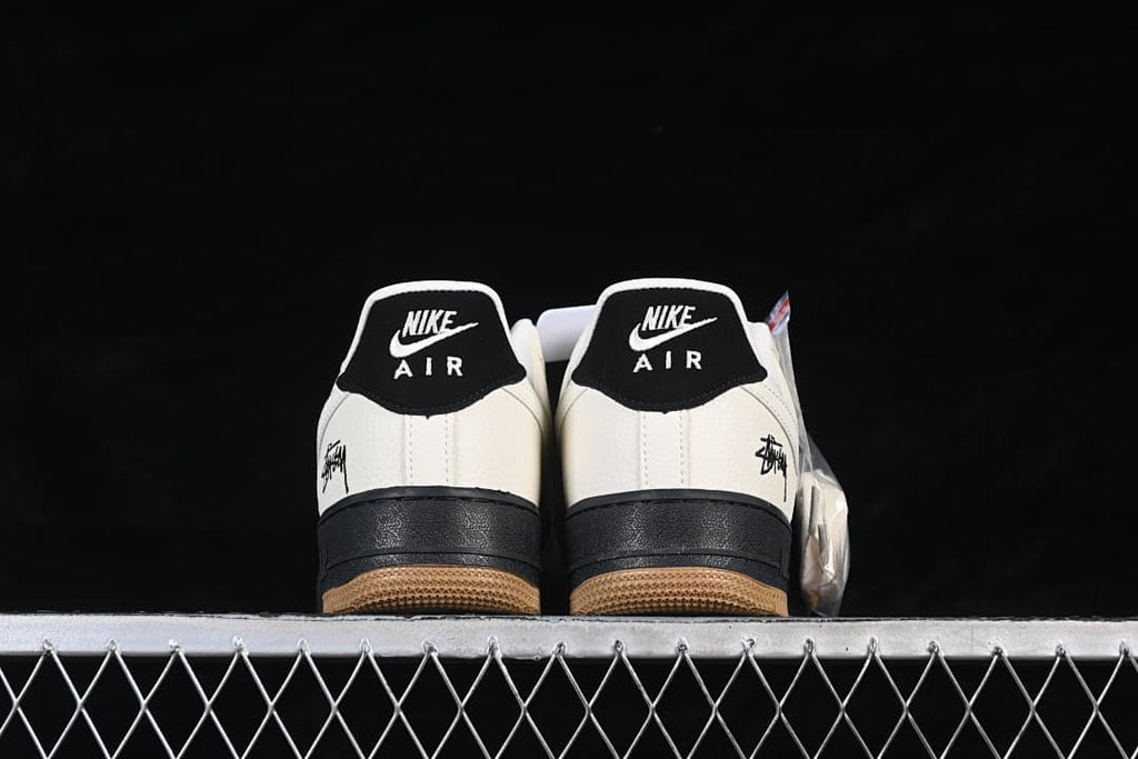 Rear view showing black heel tabs, sail heel panels, and gum outsoles