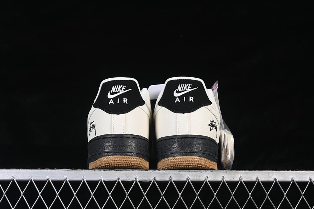 Rear view showing black heel tabs, sail heel panels, and gum outsoles