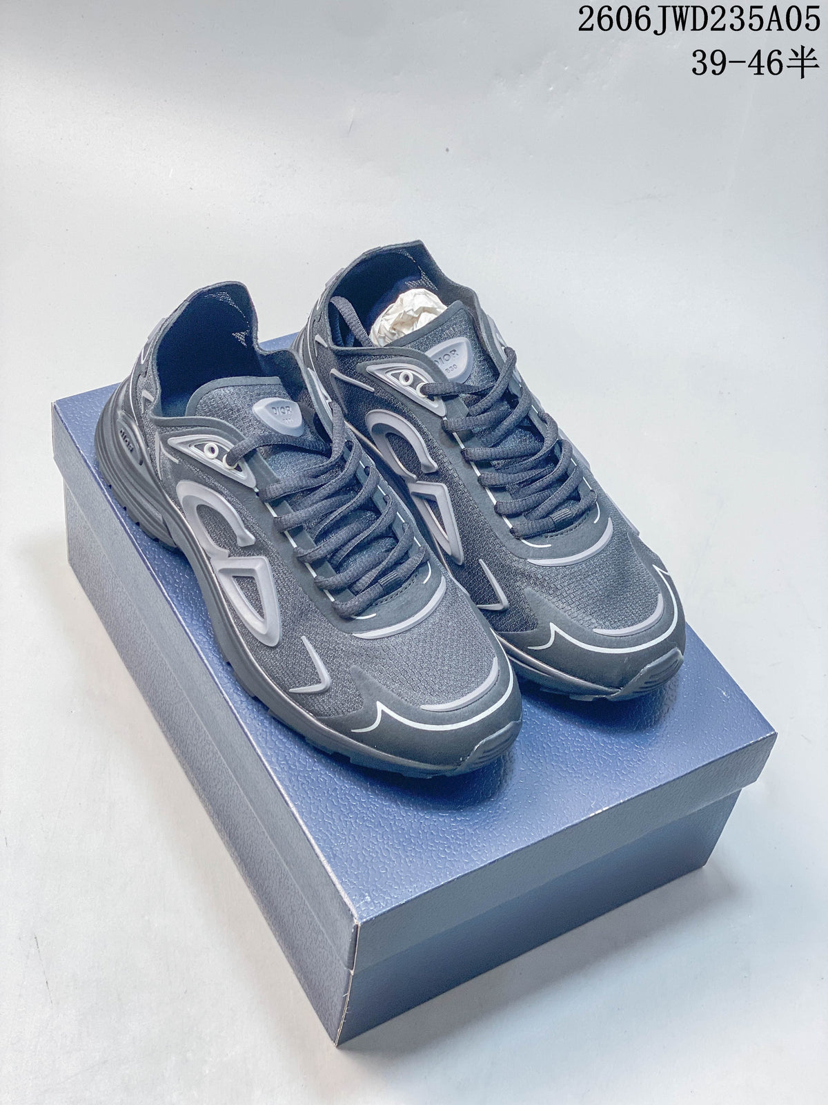 Pair of grey Dior B30 low-top sneakers on a box, viewed from above and at an angle.
