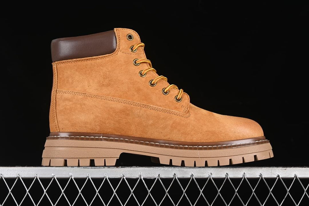 Side profile of a yellow-brown lace-up ankle boot