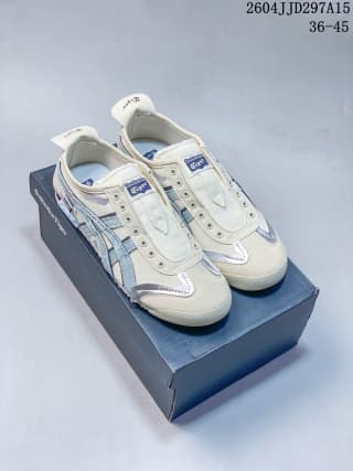 Pair of cream and blue Onitsuka Tiger sneakers displayed on the branded box.