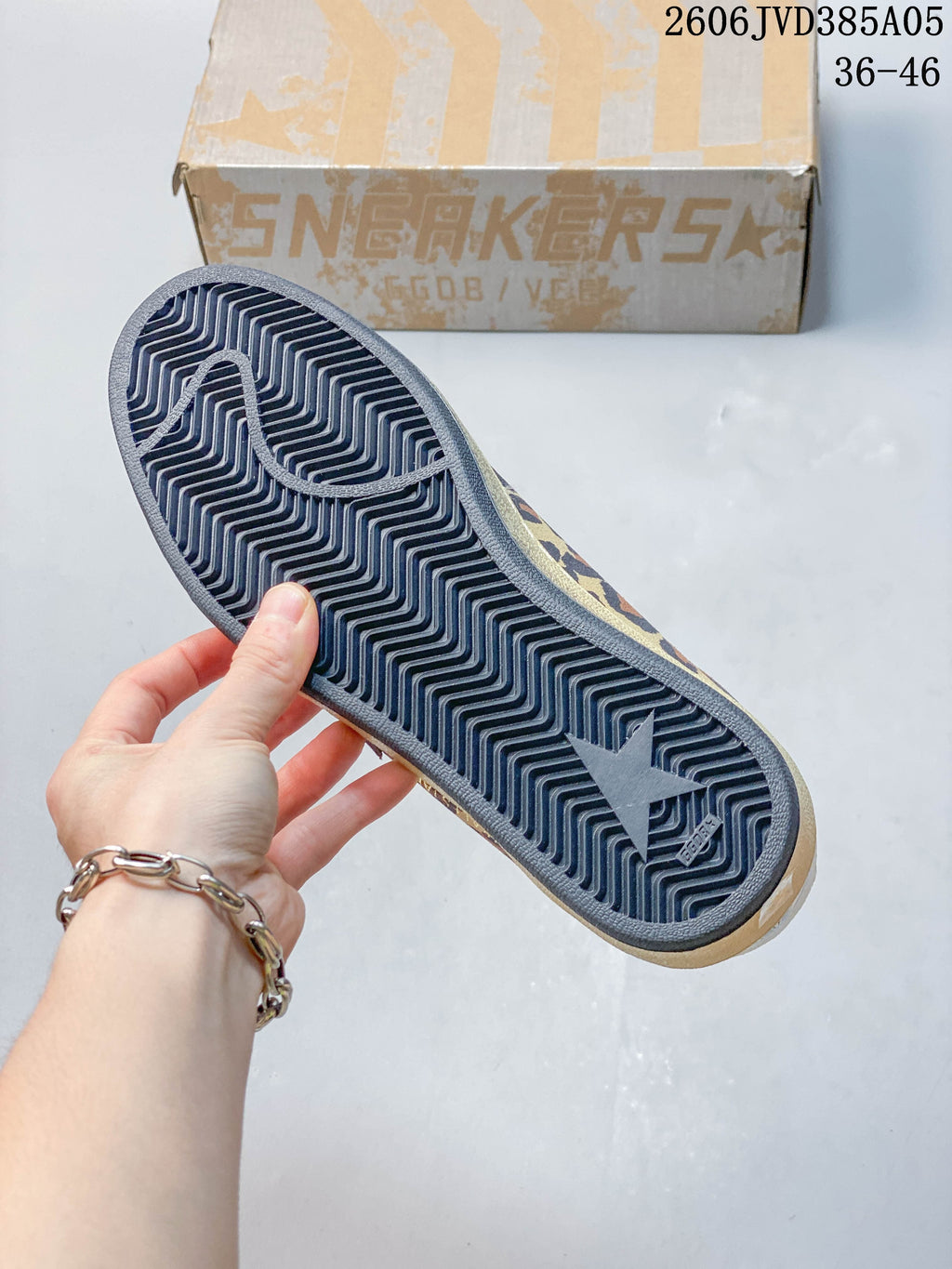 Underside of a leopard-print sneaker showing the patterned outsole.