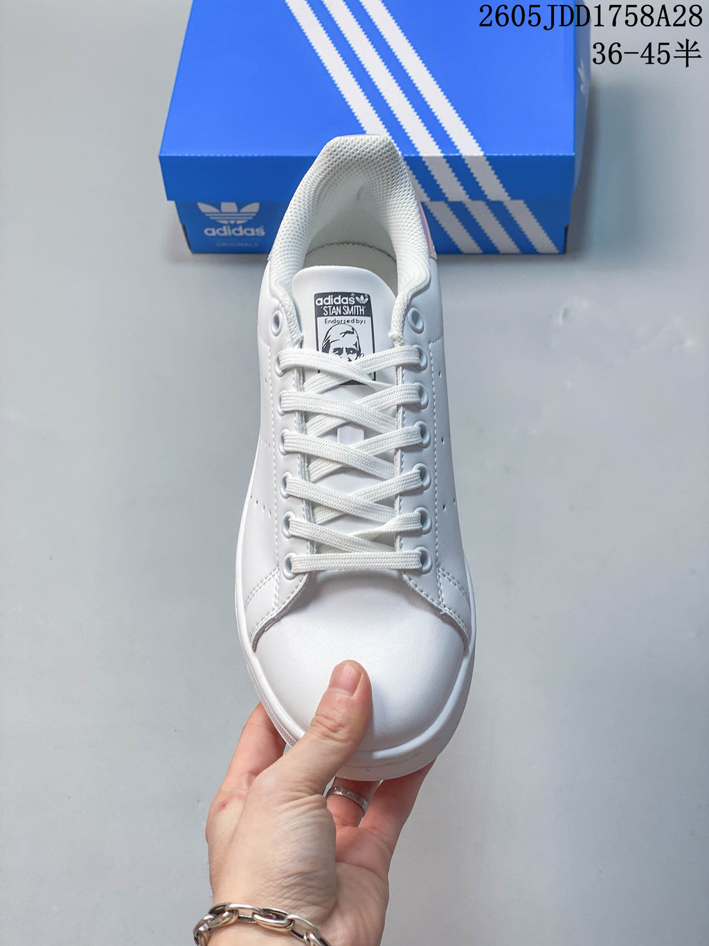 Front view of the white lace-up sneaker with Stan Smith tongue label