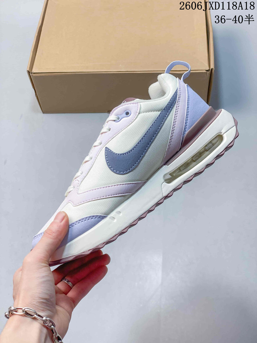 Side view of the sneaker with a blue-gray swoosh and visible heel air unit.
