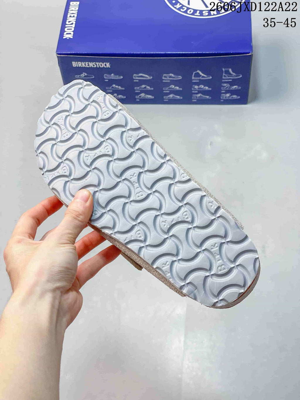Underside of a clog showing a patterned light-colored outsole.