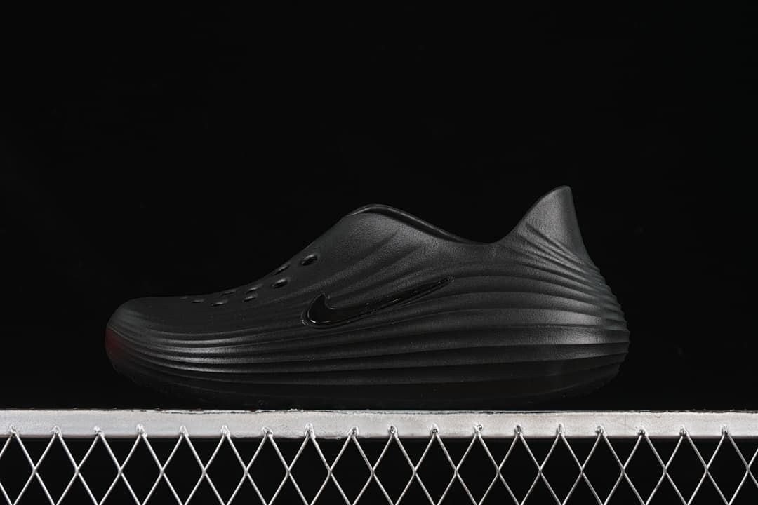 Black Nike ReactX Rejuven8 closed-toe slide shown from the side