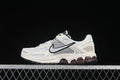 Side view of an off-white and grey Nike Zoom Vomero 5 sneaker with a silver Swoosh and dark outsole accents.