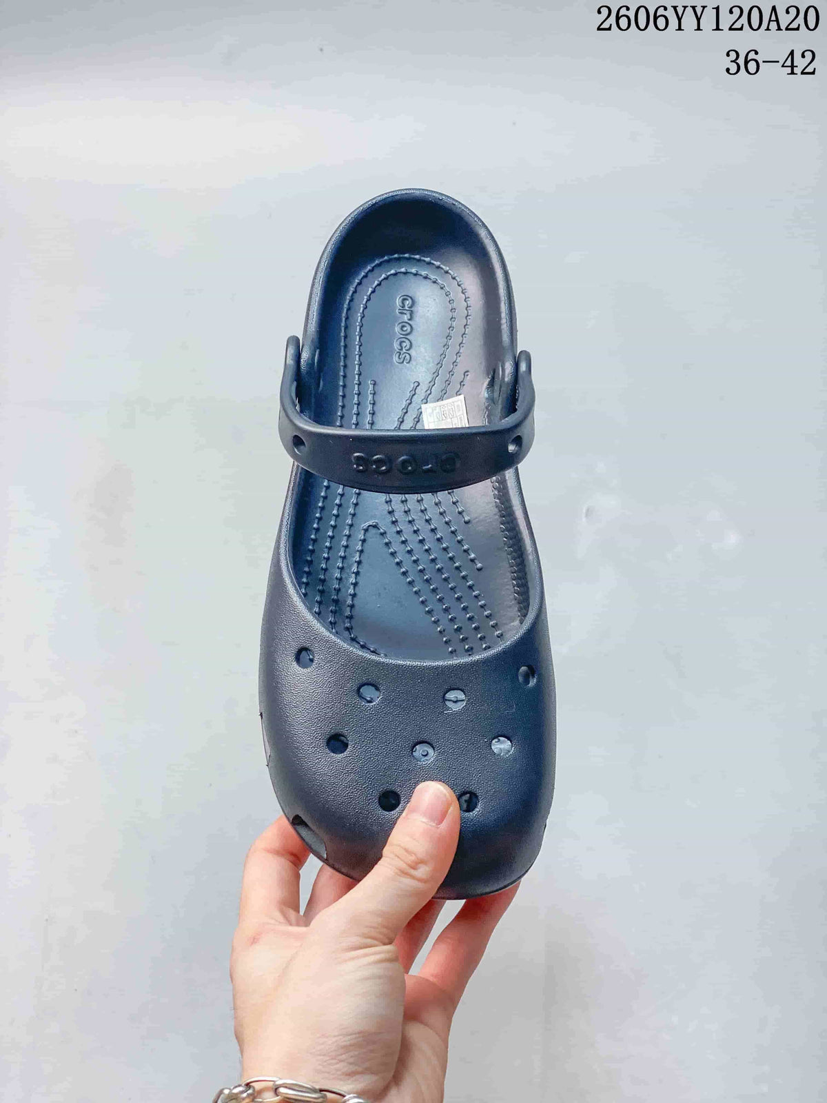 Top view of a navy clog-style shoe showing its closed toe, ventilation openings, textured footbed, and heel strap; image text shows style code 2606YY120A20 and sizes 36–42.