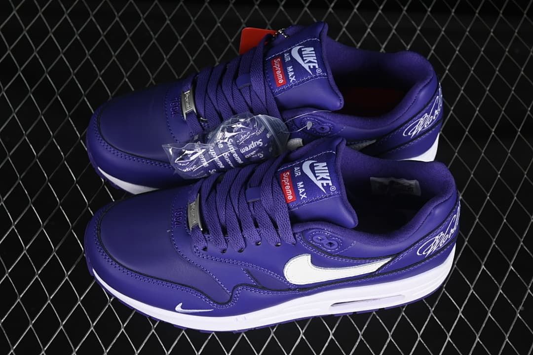 Pair of purple Nike Air Max sneakers with additional lace accessories