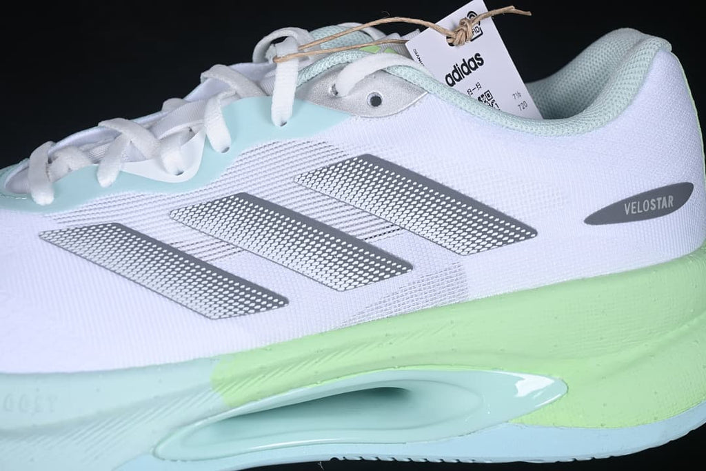 Side close-up showing silver stripes, Velostar label, and colored sole