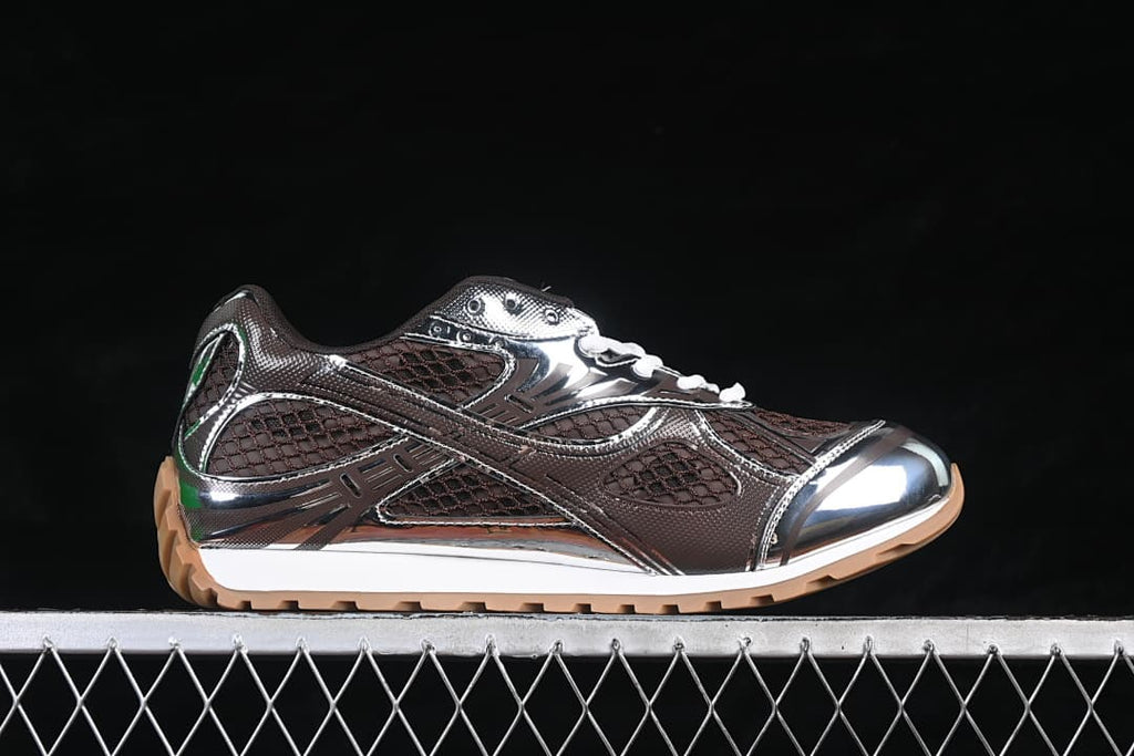 Side profile of the brown and silver-tone sneaker with white midsole and tan outsole.
