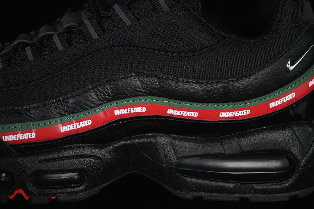 Close-up of the black layered side panels and branded red stripe