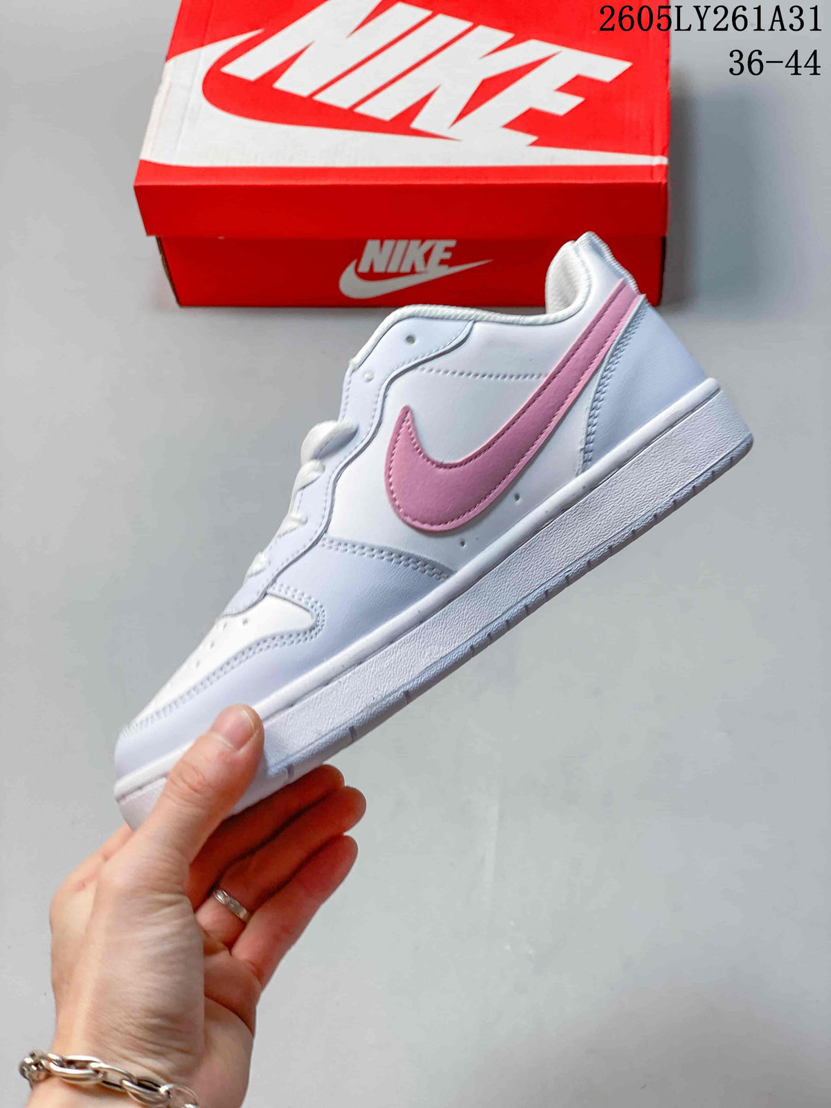 Side view of the white low-top sneaker with a pink Swoosh